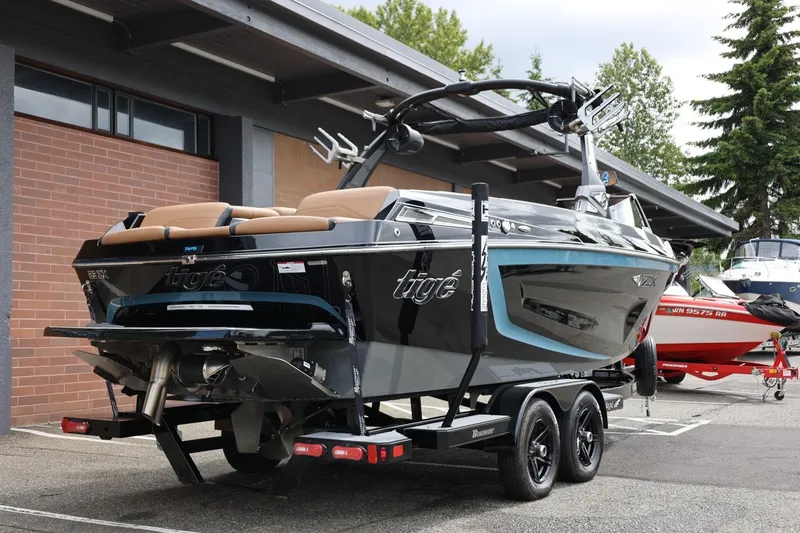 Slide: The Image of 2021 Tigé 23ZX boat on trailer, parked outdoors near a building. - 14