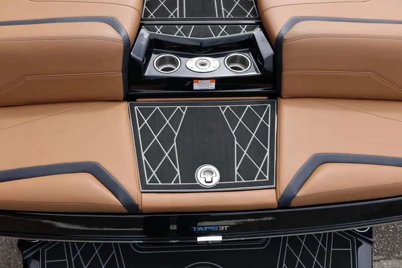 Slide: The Image of 2021 Tigé 23ZX boat interior with tan seating and black diamond-patterned flooring. - 17