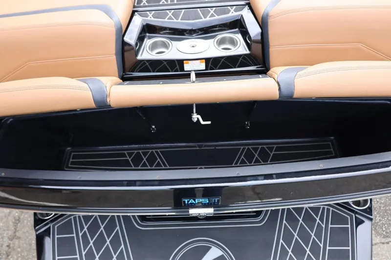 Slide: The Image of 2021 Tigé 23ZX boat interior with tan seats, cup holders, and TAPS 3T system. - 18