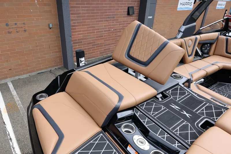 Slide: The Image of 2021 Tigé 23ZX boat interior with tan leather seating and modern design. - 19