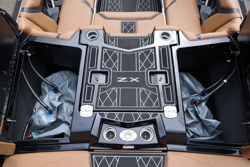 Slide: The Image of 2021 Tigé 23ZX boat interior with tan seating and storage compartments. - 20