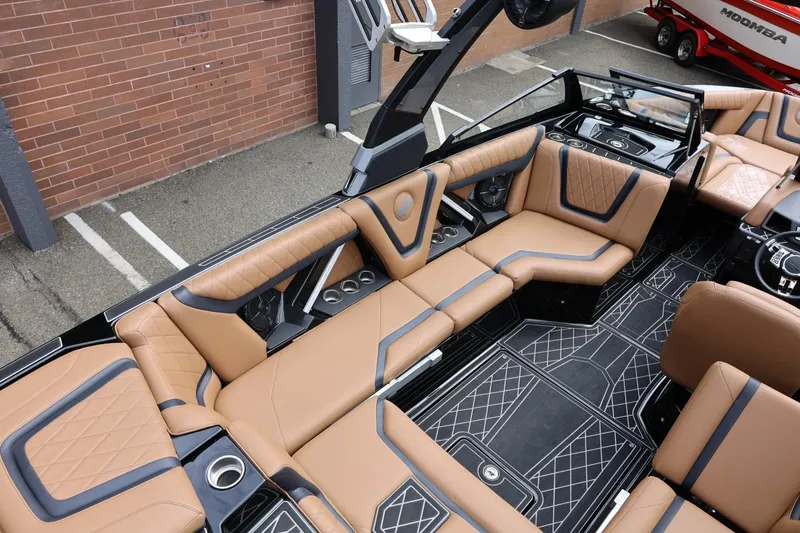 Slide: The Image of Luxurious interior of 2021 Tigé 23ZX boat with tan leather seating and modern design. - 21