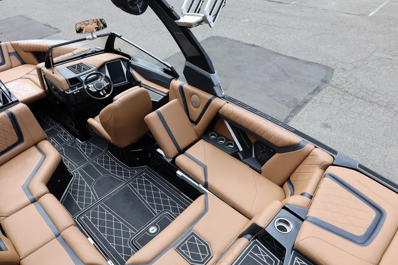 Slide: The Image of Luxurious interior of 2021 Tigé 23ZX boat with tan leather seating and modern dashboard. - 22