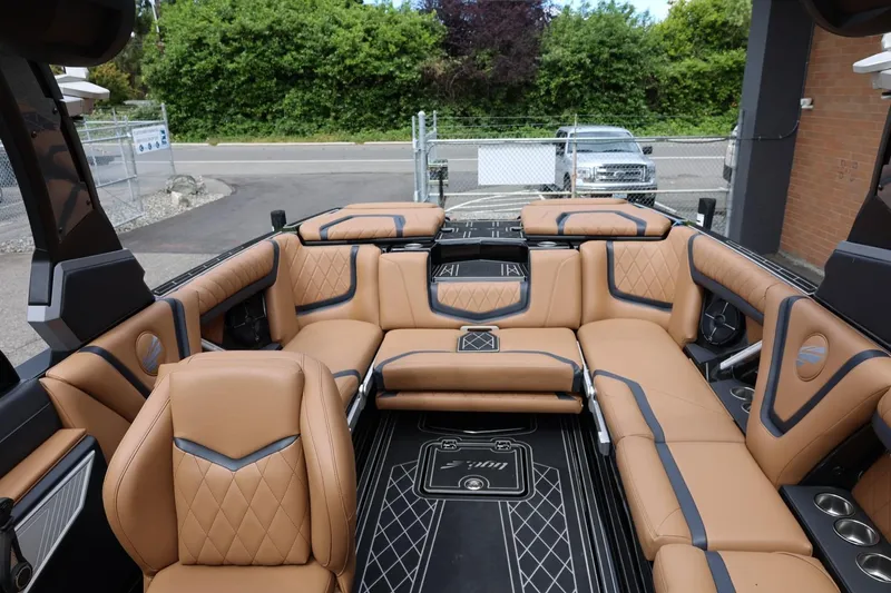 Slide: The Image of Luxurious interior of 2021 Tigé 23ZX boat with tan leather seating and modern design. - 23