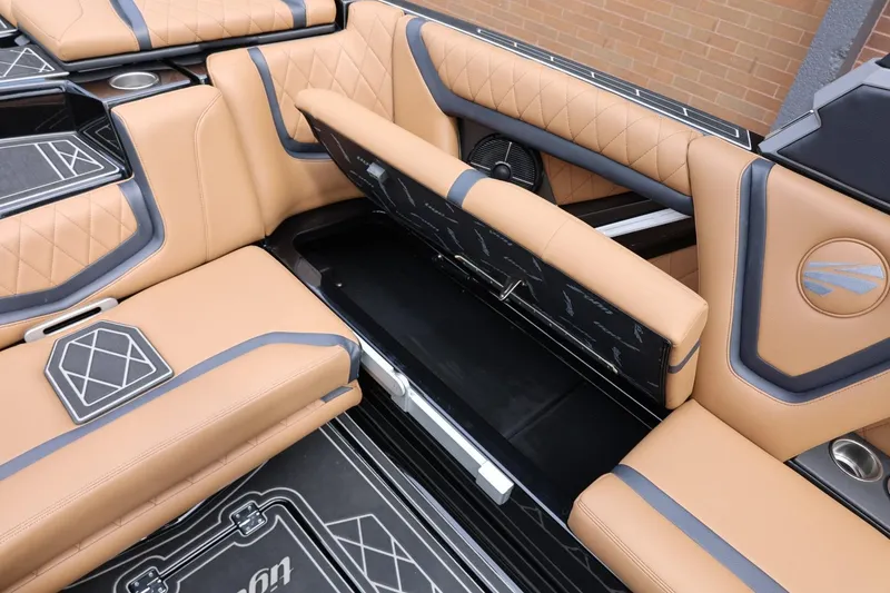Slide: The Image of 2021 Tigé 23ZX boat interior with tan leather seats and storage compartment. - 24