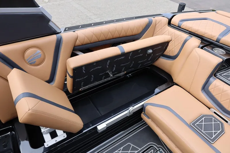 Slide: The Image of 2021 Tigé 23ZX boat interior with tan and black upholstery, featuring storage compartments. - 25