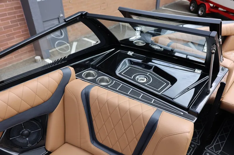 Slide: The Image of 2021 Tigé 23ZX boat interior with tan leather seats and sleek black dashboard. - 31