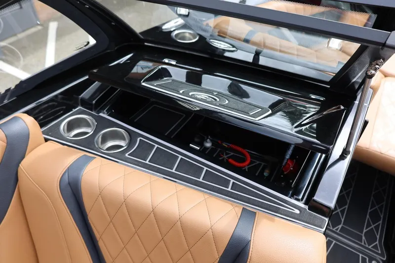 Slide: The Image of 2021 Tigé 23ZX boat interior with tan leather seats and sleek black dashboard. - 32
