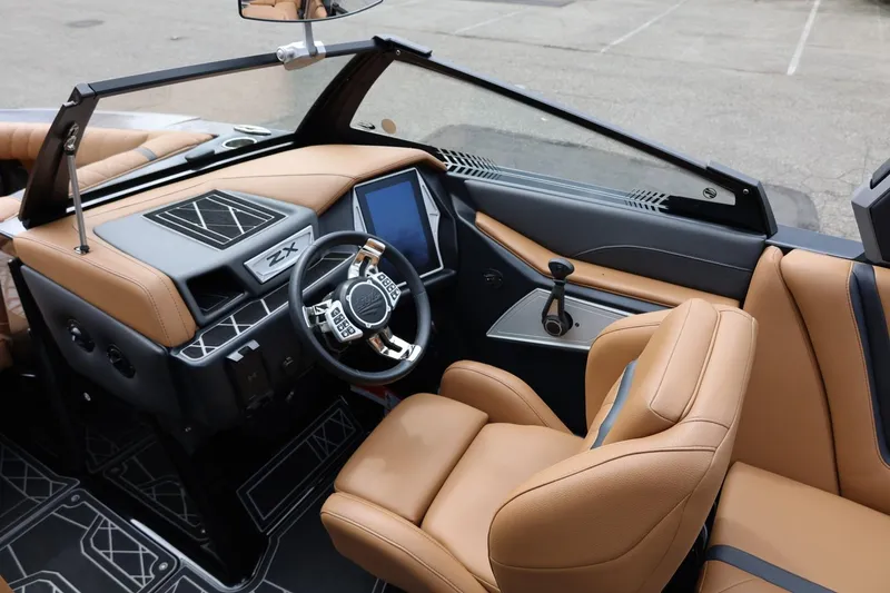 Slide: The Image of 2021 Tigé 23ZX boat interior with tan leather seats and modern dashboard design. - 33
