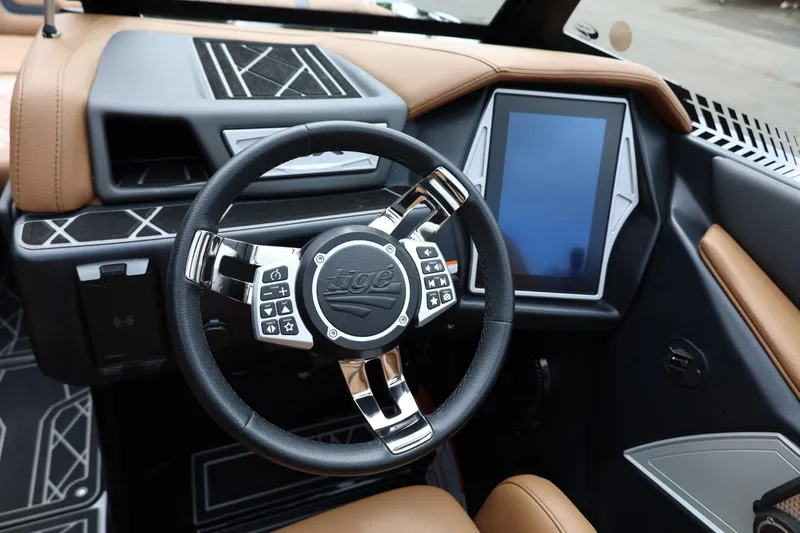 Slide: The Image of 2021 Tigé 23ZX boat dashboard with touchscreen and multifunction steering wheel. - 34