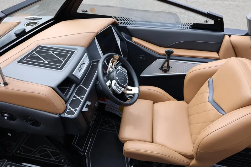Slide: The Image of 2021 Tigé 23ZX boat interior with tan leather seats and modern dashboard design. - 35