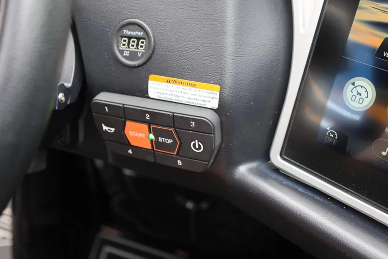 Slide: The Image of Control panel of a 2021 Tigé 23ZX boat with digital display and buttons. - 38