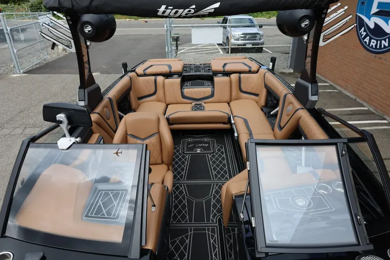 Slide: The Image of 2021 Tigé 23ZX boat interior with luxurious tan seating and modern dashboard. - 39