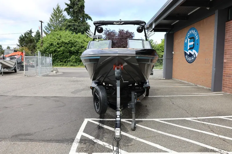 Slide: The Image of 2021 Tigé 23ZX boat on trailer at dealership parking lot. - 5