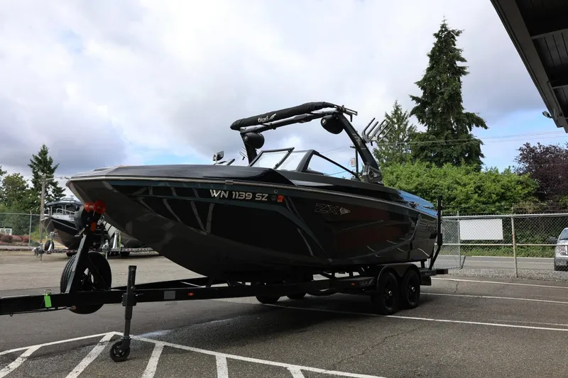 Slide: The Image of 2021 Tigé 23ZX boat on trailer in parking lot, overcast sky. - 8