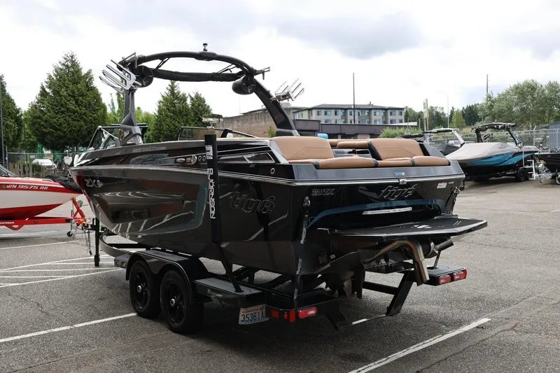 Slide: The Image of 2021 Tigé 23ZX boat on trailer, parked outdoors, showcasing sleek design and modern features. - 9