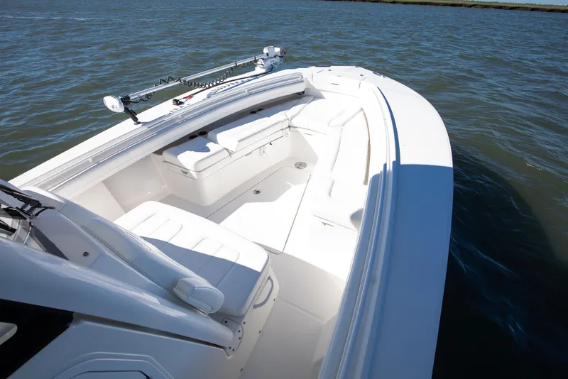 Slide: The Image of 2022 Regulator 28 Forward Seating boat on water, showcasing spacious seating and sleek design. - 9