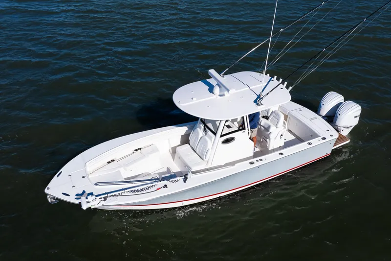 Slide: The Image of 2022 Regulator 28 Forward Seating boat on water, featuring dual outboard engines. - 3