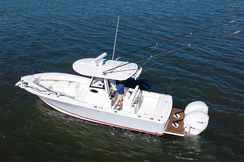 Slide: The Image of 2022 Regulator 28 Forward Seating boat on open water, featuring dual Yamaha engines. - 18