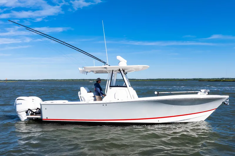 Slide: The Image of 2022 Regulator 28 Forward Seating boat on open water, featuring dual Yamaha engines. - 24