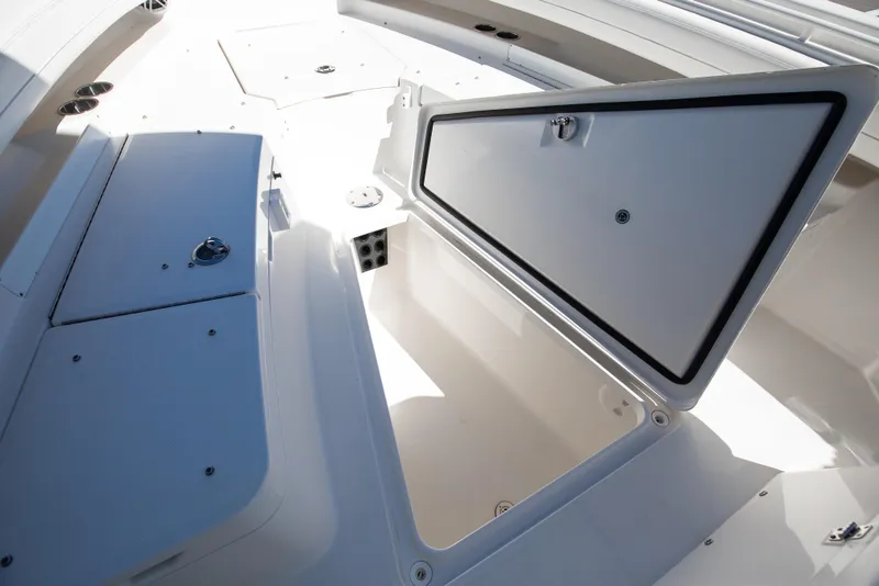 Slide: The Image of 2022 Regulator 28 Forward Seating boat with open storage compartments. - 13