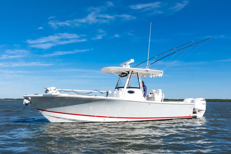 The Image of 2022 Regulator 28 Forward Seating boat on water under clear blue sky. - 1