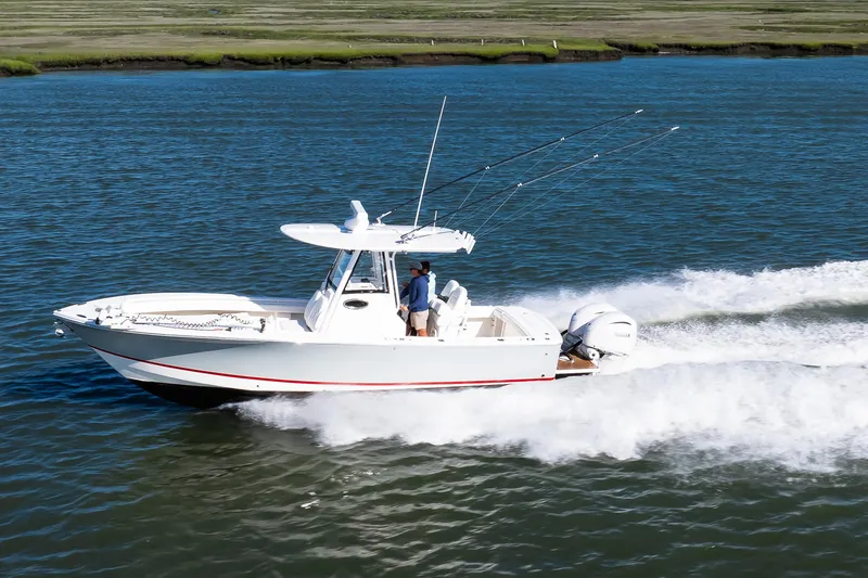 Slide: The Image of 2022 Regulator 28 Forward Seating boat cruising on open water. - 22