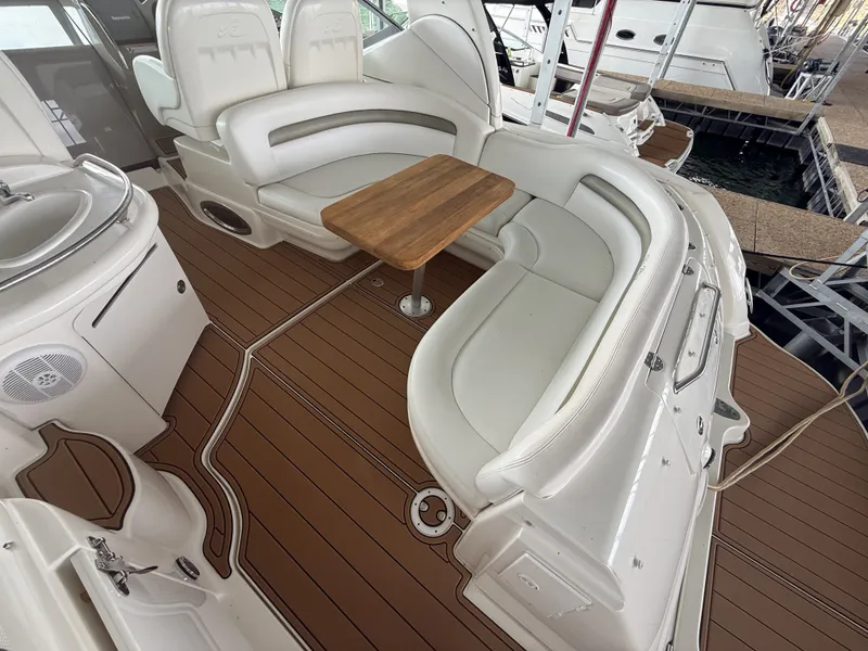Slide: The Image of The image shows the cockpit of a 2007 Sea Ray 340 Sundancer with white seating and a wooden table. - 15