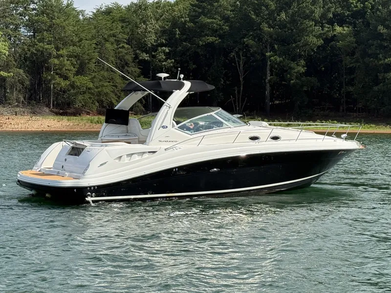 Slide: The Image of A 2007 Sea Ray 340 Sundancer on a calm lake, surrounded by trees. - 7