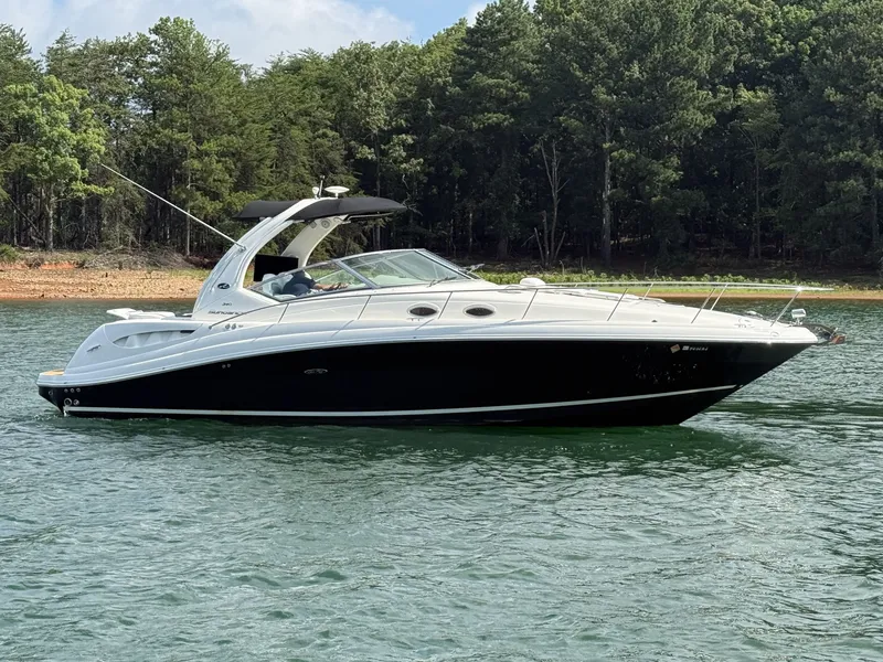 Slide: The Image of A 2007 Sea Ray 340 Sundancer on a calm lake, surrounded by trees. - 4