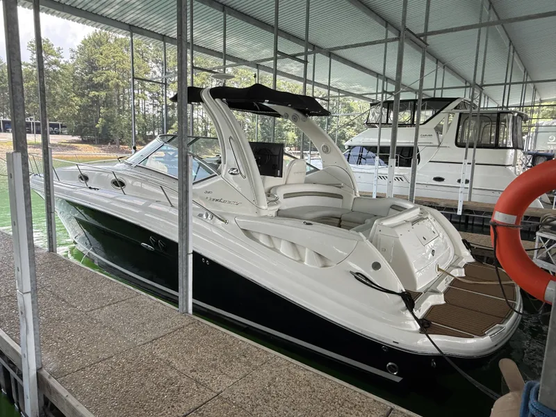 The Image of A 2007 Sea Ray 340 Sundancer is docked under a covered area. - 1