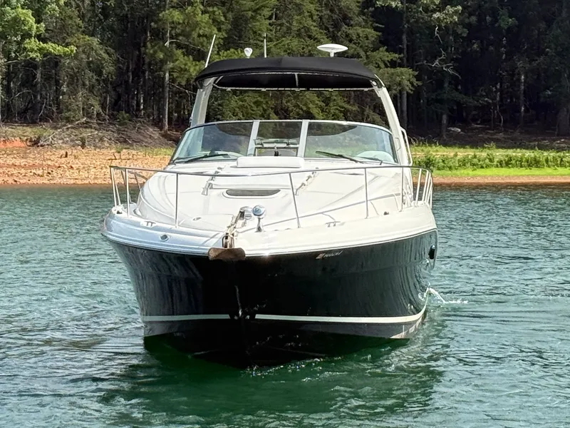 Slide: The Image of A 2007 Sea Ray 340 Sundancer cruising on a calm lake, surrounded by forest. - 3