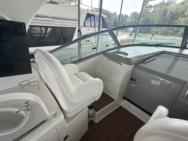 Slide: The Image of The image shows the cockpit of a 2007 Sea Ray 340 Sundancer with white seats and a sink. - 19