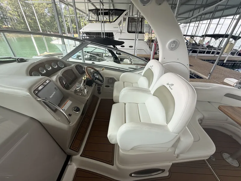 Slide: The Image of The image shows the cockpit of a 2007 Sea Ray 340 Sundancer with two white seats. - 10