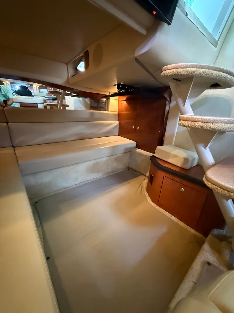 Slide: The Image of Interior of a 2007 Sea Ray 340 Sundancer with beige upholstery and wooden cabinets. - 29