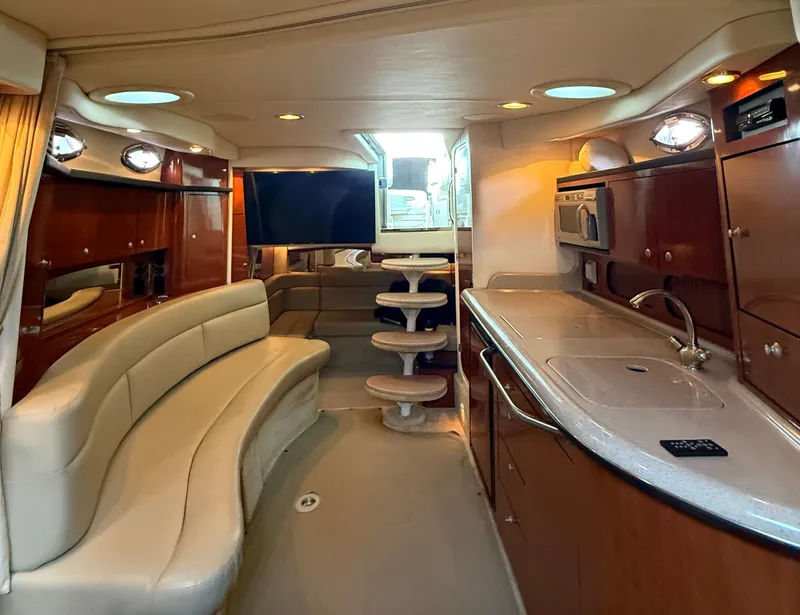 Slide: The Image of Interior of a 2007 Sea Ray 340 Sundancer with elegant leather seating and modern kitchen. - 22