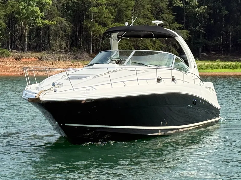 Slide: The Image of A 2007 Sea Ray 340 Sundancer on a calm lake, surrounded by trees. - 5