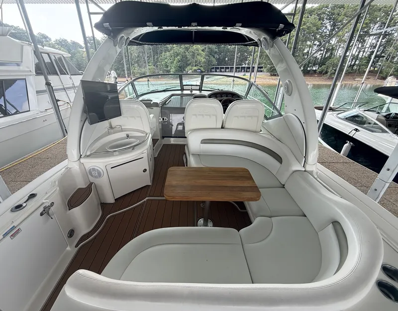 Slide: The Image of The image shows the cockpit of a 2007 Sea Ray 340 Sundancer with white seating and a wooden table. - 13