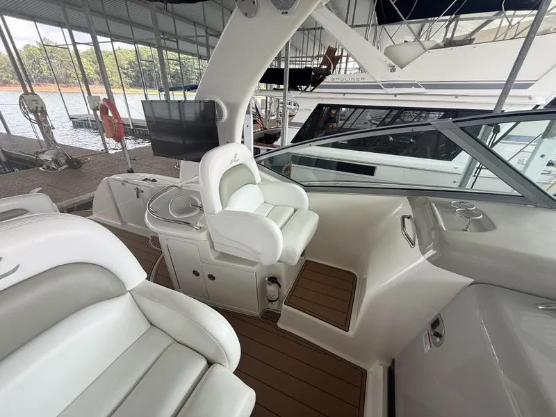Slide: The Image of The image shows the cockpit of a 2007 Sea Ray 340 Sundancer with white seats and wood flooring. - 18