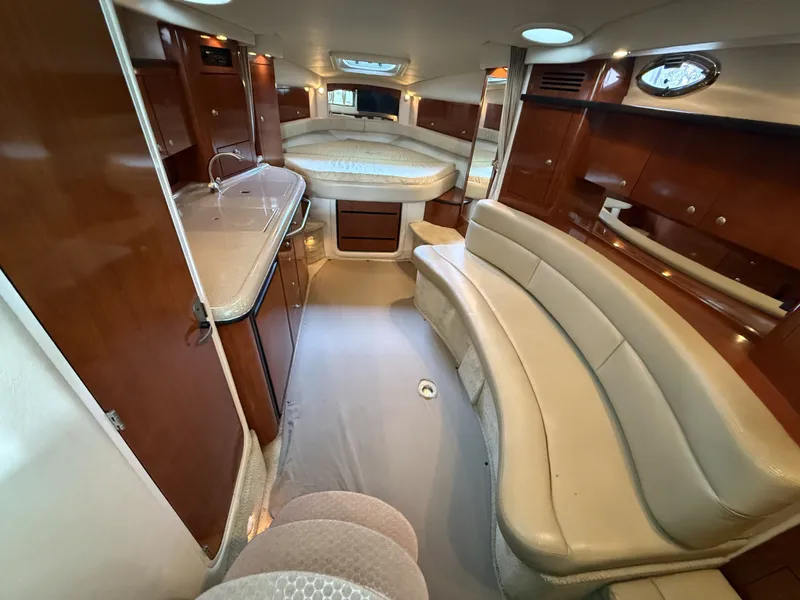 Slide: The Image of Interior of a 2007 Sea Ray 340 Sundancer with elegant leather sofas and wooden cabinetry. - 20