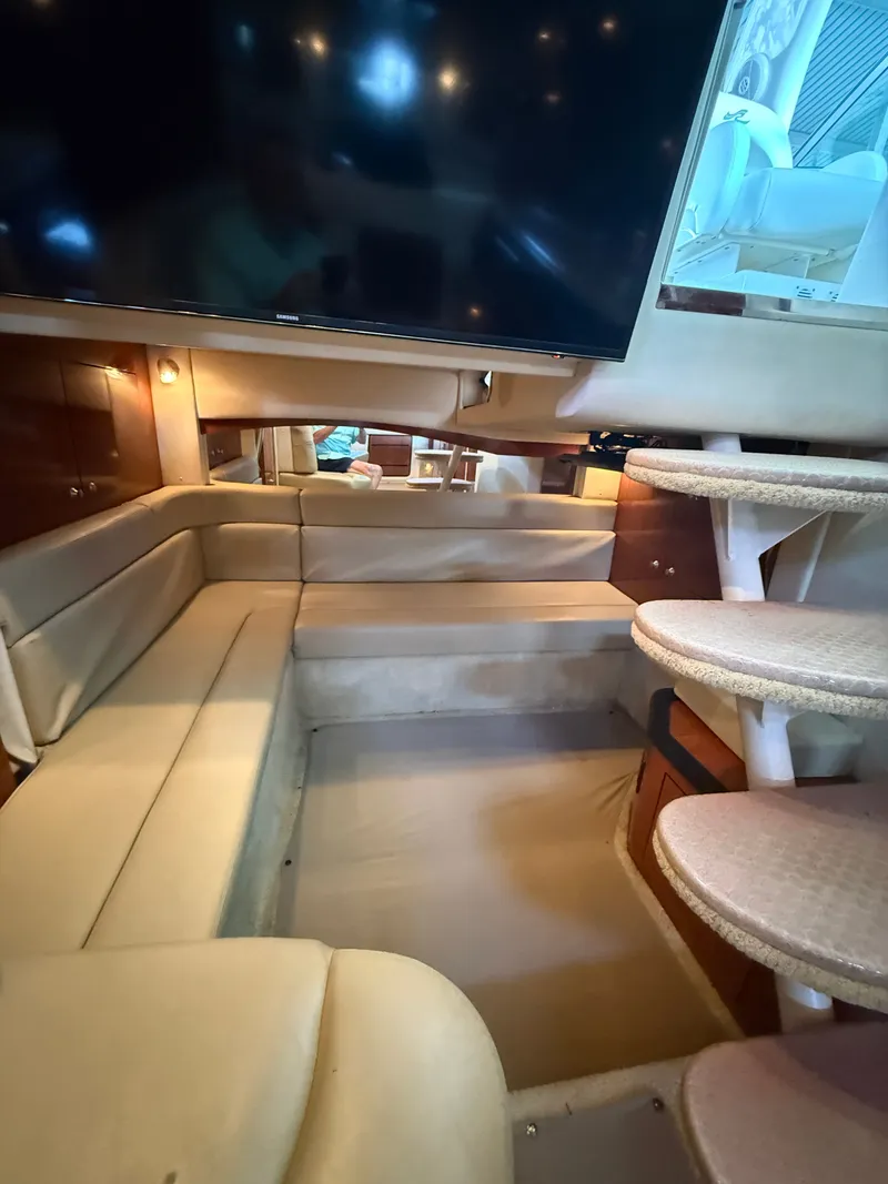 Slide: The Image of Interior of a 2007 Sea Ray 340 Sundancer with beige upholstered seating and a staircase. - 27
