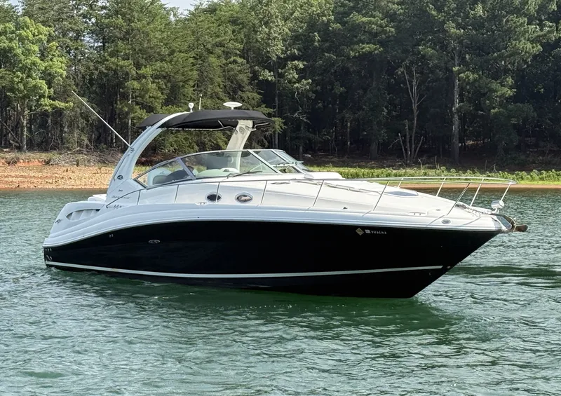 Slide: The Image of A 2007 Sea Ray 340 Sundancer on calm water, surrounded by trees. - 6