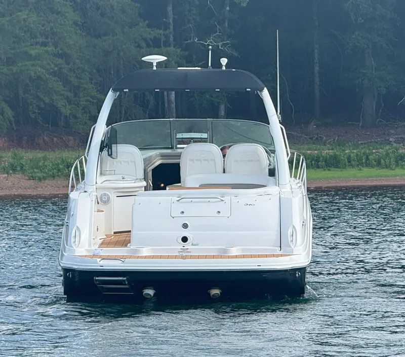 Slide: The Image of A 2007 Sea Ray 340 Sundancer on calm water, surrounded by forest. - 2