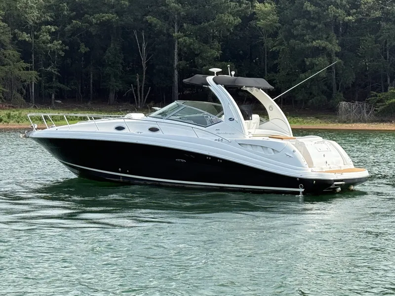 Slide: The Image of A 2007 Sea Ray 340 Sundancer on calm water, surrounded by trees. - 8