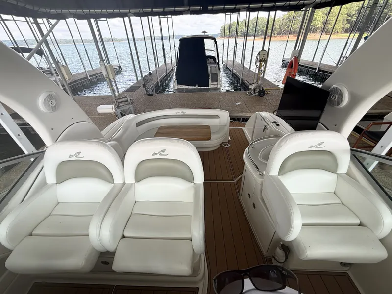 Slide: The Image of The image shows the cockpit of a 2007 Sea Ray 340 Sundancer with white seats and wood flooring. - 16