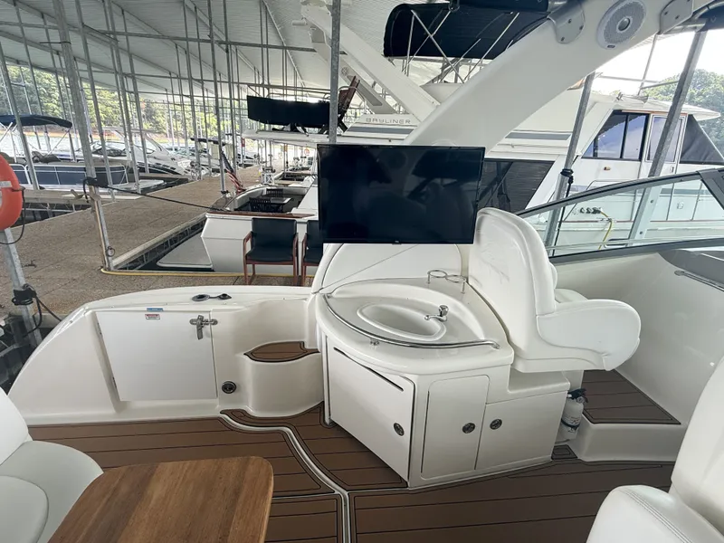 Slide: The Image of The image shows the cockpit of a 2007 Sea Ray 340 Sundancer. There's a sink area and a TV. - 17