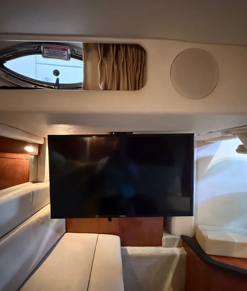 Slide: The Image of The interior of a 2007 Sea Ray 340 Sundancer features a flat-screen TV and seating area. - 31