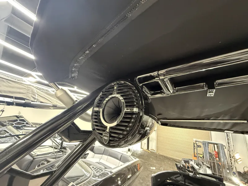 Slide: The Image of Close-up of a speaker on a boat with a black canopy. - 13