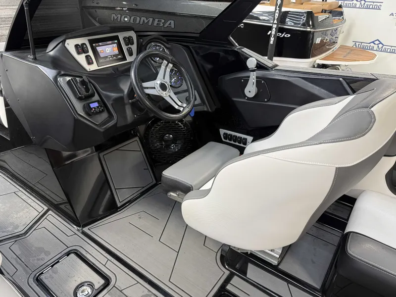 Slide: The Image of Interior of a modern motorboat with gray and white seats, steering wheel, and dashboard. - 17