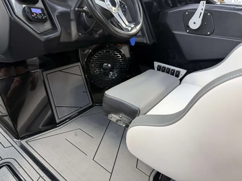 Slide: The Image of Interior of a 2020 Supreme ZS 232 boat with gray seat and steering wheel. - 18